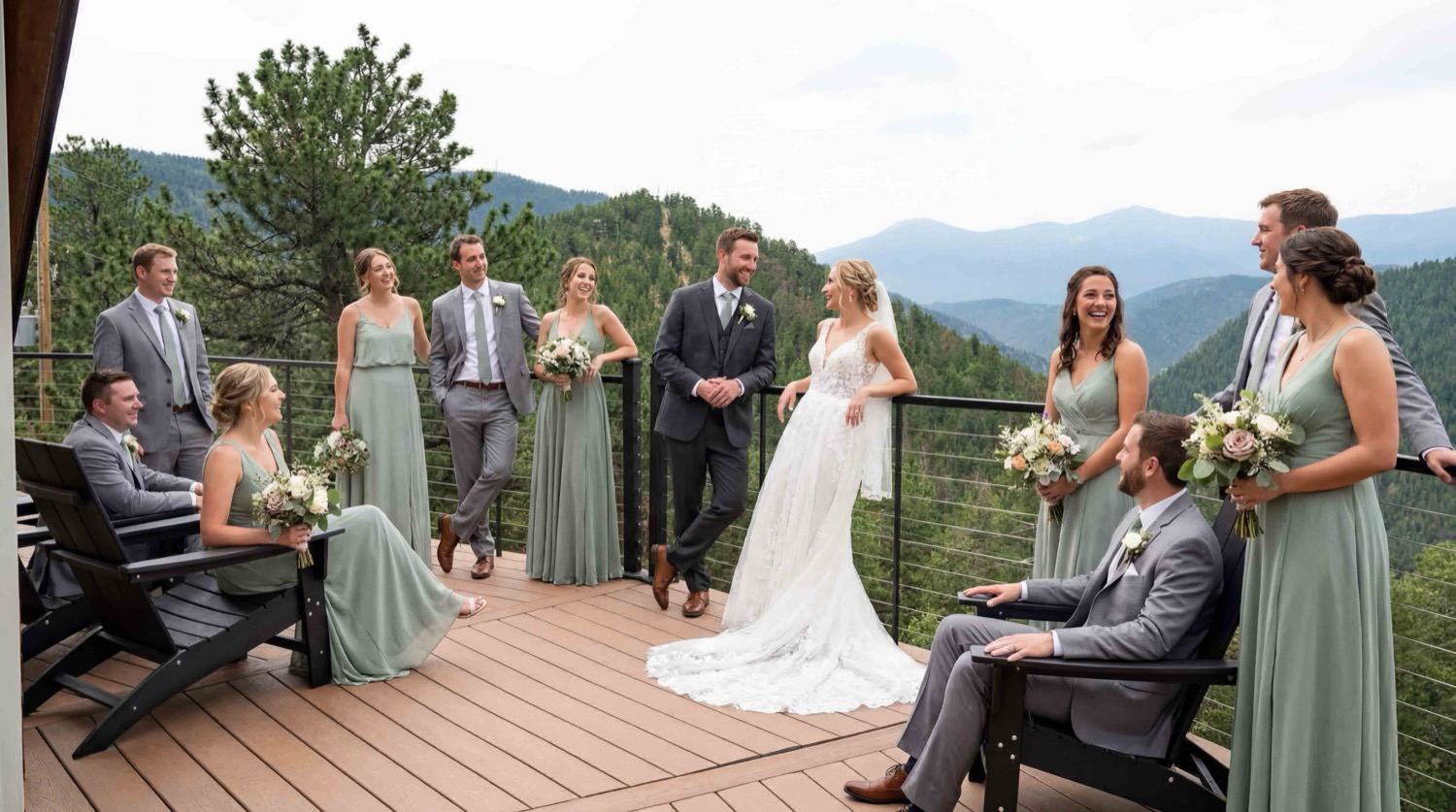 A wedding party on the dome's wraparound deck with the mountains behind